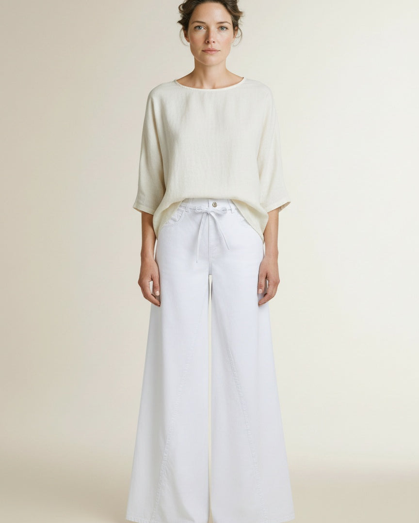 Full body view of the model wearing Mac Wide Jeans White Denim