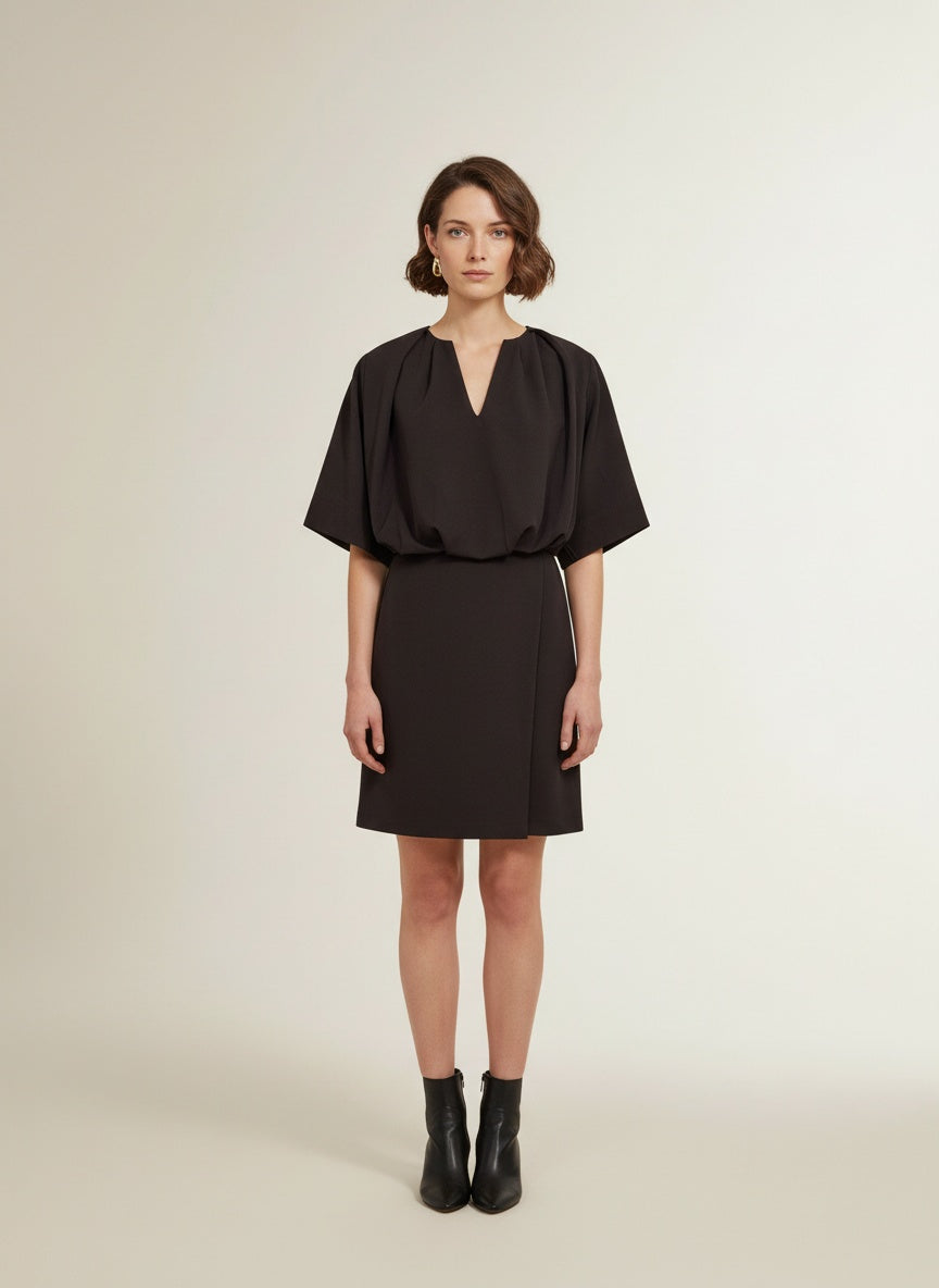 Full body view of the model wearing Co'couture Falconcc V-pleat Mini Dress Bison