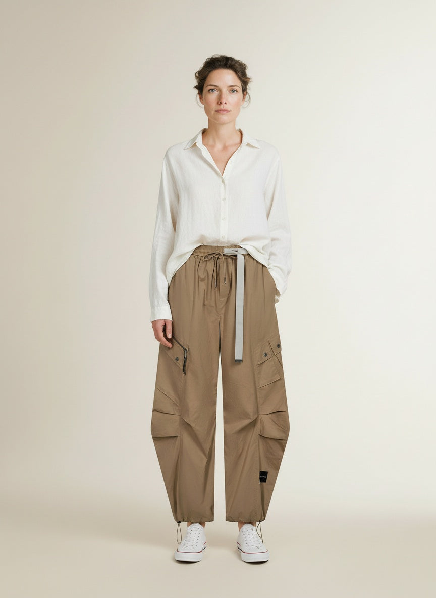 Full body view of the model wearing Haute L'amitiÉ Air Zip Tall Pant Walnut