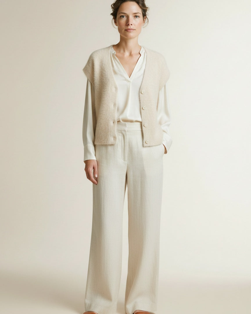 Full body view of the model wearing Red Button Sleeveless Fuzzy Cream
