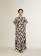 Full body view of the model wearing Co'couture Memphiscc Dress Off White