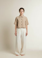 Full body view of the model wearing Aaiko Vanessa Ray 560 Blouses Sand