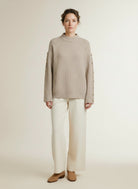Full body view of the model wearing Co'couture Rowcc Button Sleeve Knit Bone