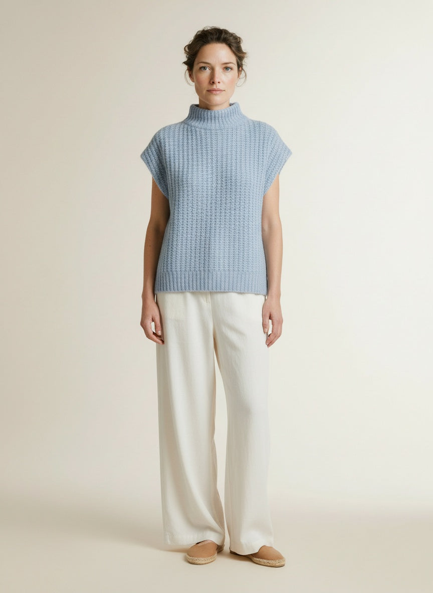 Full body view of the model wearing Co'couture Rainacc Knit Vest Pale Blue