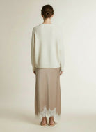 Back pose of the model wearing Co'couture Iduncc Lace Skirt Bisquit