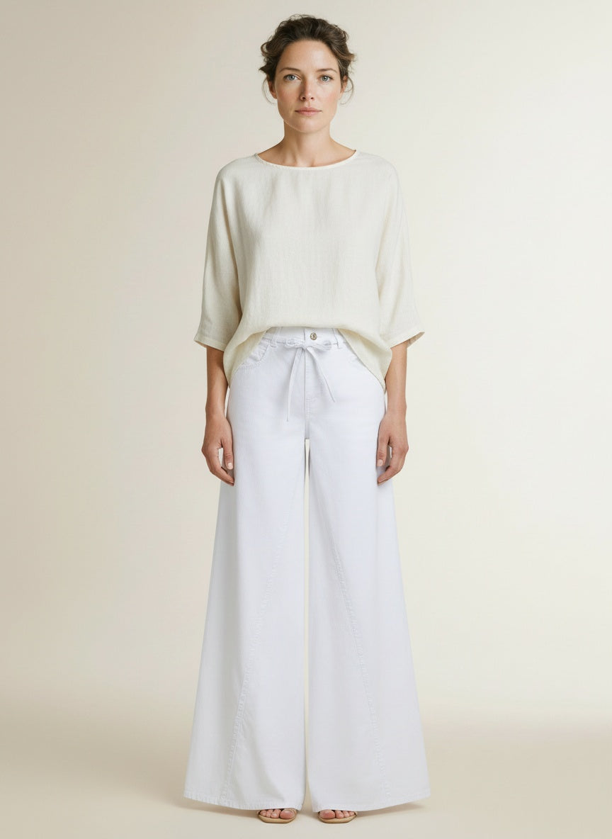 Full body view of the model wearing Mac Wide Jeans White Denim