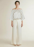 Full body view of the model wearing Aaiko Maddy Dot Pes 511 Top Lesblancs