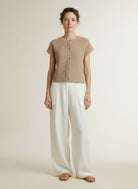 Full body view of the model wearing Red Button Sleeveless Knit Boucle Latte