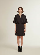 Full body view of the model wearing Co'couture Falconcc V-pleat Mini Dress Bison