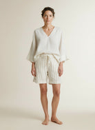 Full body view of the model wearing Red Button Camille Short Linen/co Stripe Dark Sand