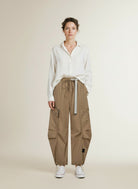 Full body view of the model wearing Haute L'amitiÉ Air Zip Tall Pant Walnut