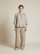 Full body view of the model wearing Msch Copenhagen Mschviana Ginia 2 4 Top Sand Melange