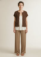 Full body view of the model wearing Red Button Sleeveless Knit Boucle Mud