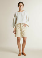 Full body view of the model wearing Red Button Kate Short Colour Butter Yellow